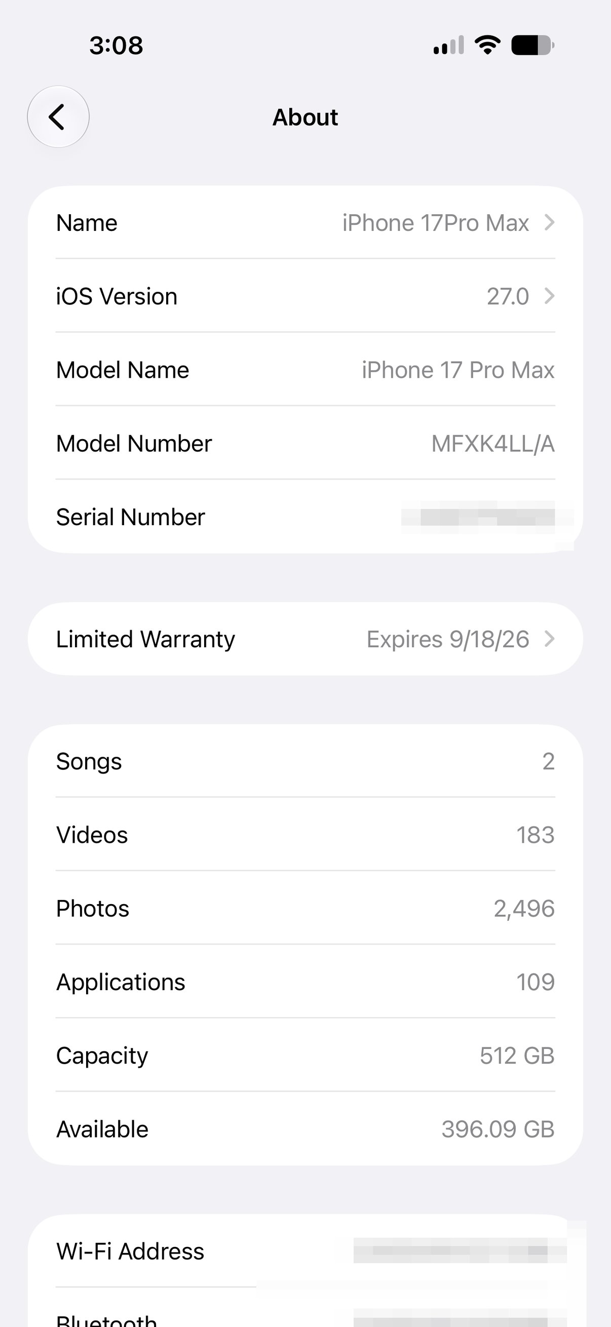 The iPhone About screen showing iOS Version 27.0 in the Settings app. Serial number and addresses are blurred.