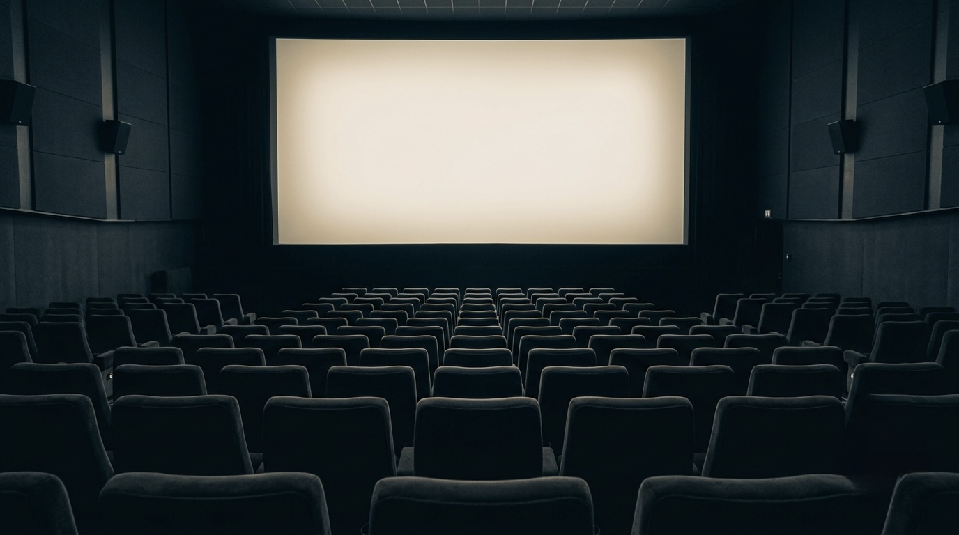 A moody photo of an empty movie theater with a single glowing screen, no titles or logos, cinematic.